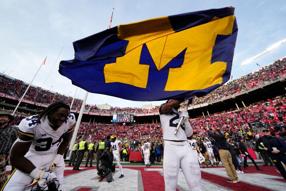 Nov 26, 2022; Columbus, Ohio, USA;  Michigan Wolverines linebacker Michael Barrett (23) waves the Michigan flag following their 45-23 win over the Ohio State Buckeyes in the NCAA football game at Ohio Stadium. Mandatory Credit: Adam Cairns-The Columbus Dispatch