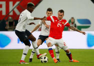 Soccer Football - International Friendly - Russia vs France - Saint-Petersburg Stadium, Saint Petersburg, Russia - March 27, 2018 Russia’s Anton Zabolotny in action with France’s Paul Pogba and Laurent Koscielny REUTERS/Grigory Dukor
