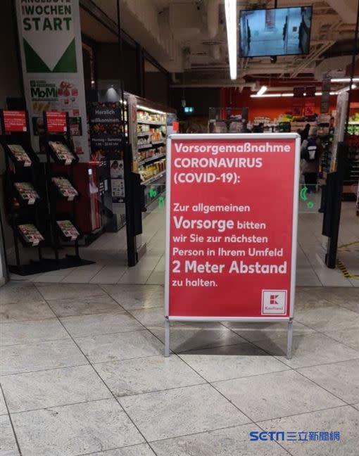 德國考芙蘭超市（Kaufland）入口公告，譯：Covid 19 預防措施：為了預防病毒請和人保持2m的距離。（圖／讀者提供）