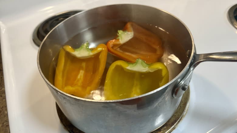 peppers in pot of water on stove