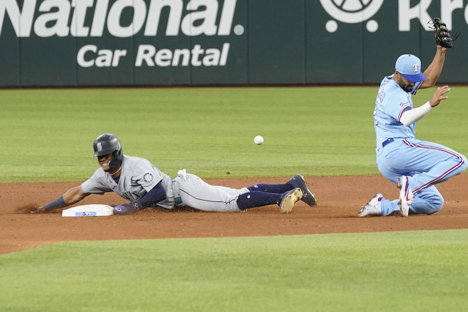Seattle Mariners' Julio Rodriguez, left, steals second base against Texas Rangers second baseman Marcus Semien, right, during the fifth inning of a baseball game in Arlington, Texas, Sunday, June 5, 2022. (AP Photo/LM Otero)
