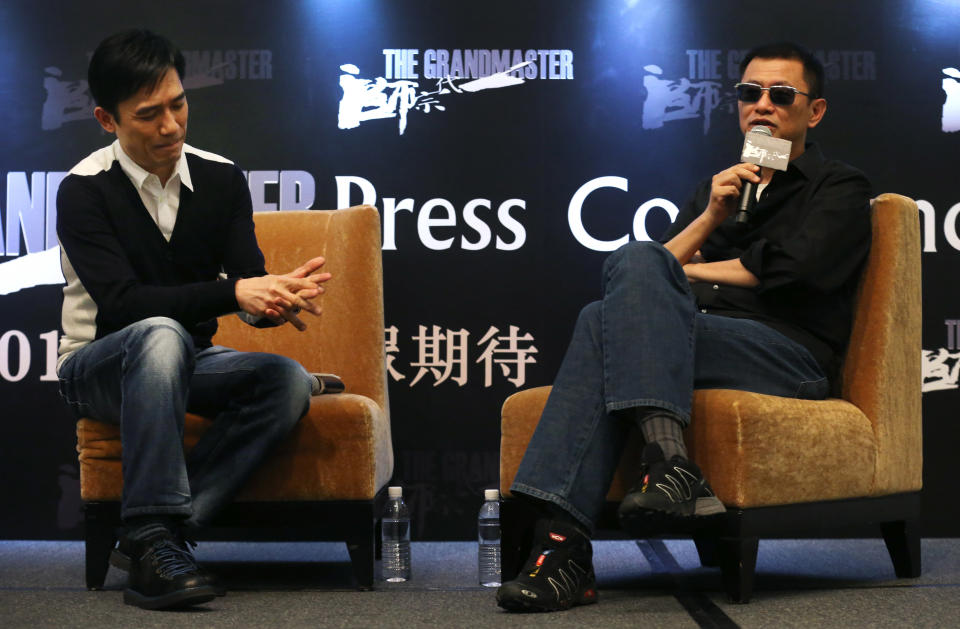 Movie director Wong Kar-wai, right, speaks while actor Tony Leung listens during a press conference on Wednesday, Jan. 23, 2013 in Singapore. For a director and actor who have worked together for about two decades, there did not seem to be much chemistry between Wong and Leung at the news conference promoting their new movie "The Grandmaster." (AP Photo/Wong Maye-E)