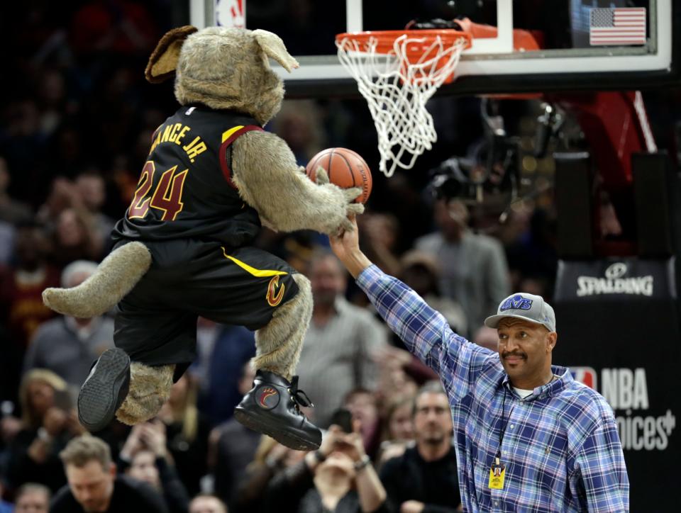 Former Cavaliers star Larry Nance Sr., right, holds the ball for team mascot Moondog during a timeout in the first half of a game vs. the Washington Wizards, Thursday, Feb. 22, 2018, in Cleveland.