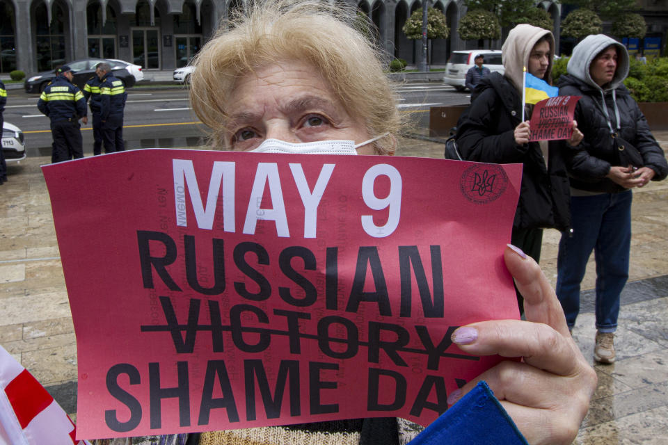 A demonstrator holds a poster during an anti-war protest against the Russian invasion of Ukraine in Tbilisi, Georgia, Sunday, May 8, 2022, a day before Russia celebrates Victory Day, marking 77 years of the victory in WWII. (AP Photo/Shakh Aivazov)