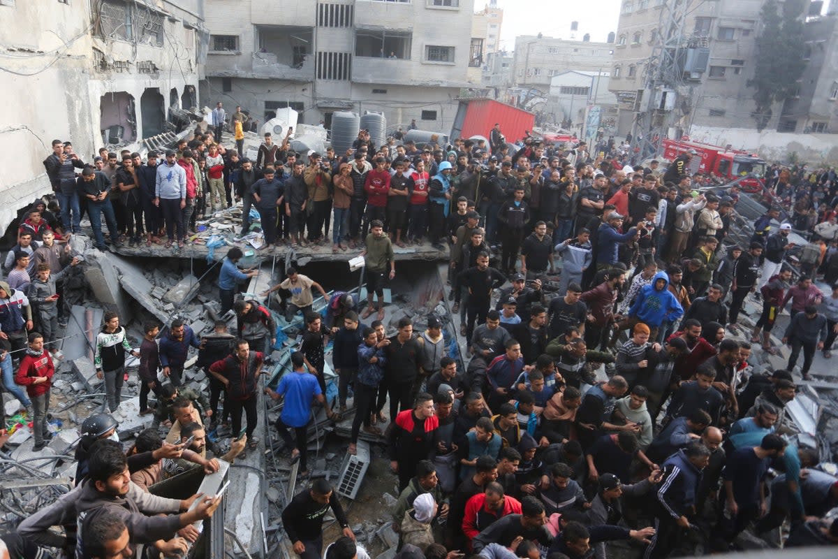 Palestinians gather after an Israeli strike in Rafah, Gaza  (AP)