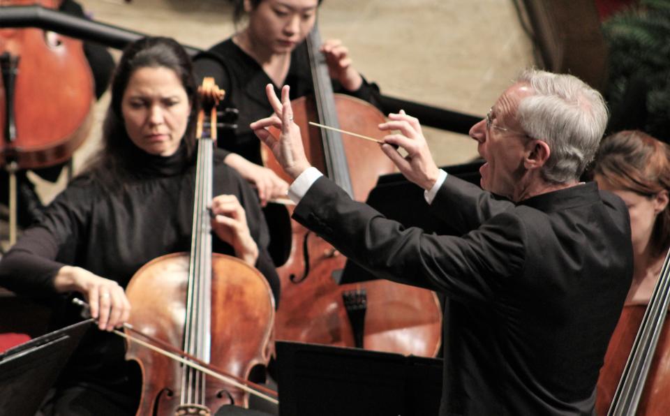 Abilene Philharmonic music director David Itkin leads his musicians and three university choirs during an April performance of Mozart's "Requiem."