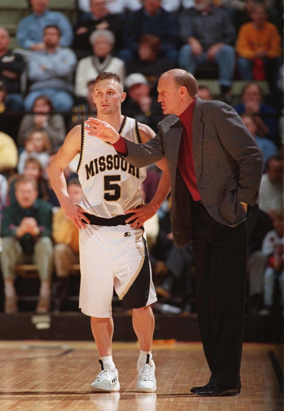 In this file photo, Missouri coach Norm Stewart (right) gives instructions next to Jason Sutherland. Stewart’s Tigers, led by Sutherland’s 18 points took down No. 1 Kansas on Feb. 4, 1997.