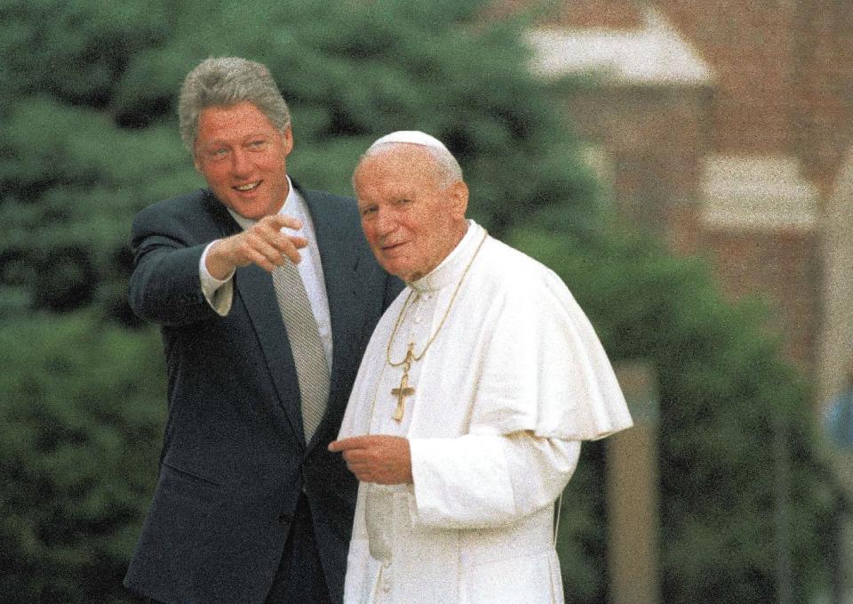 FILE - In this Aug. 12, 1993, file photo, U.S. President Bill Clinton points out people in the crowd to Pope John Paul II as he arrives in Denver, Co. President Obama is scheduled to meet Pope Francis for the first time on Thursday, March 27, 2014, at the Vatican. (AP Photo/Bruno Musconi, File)
