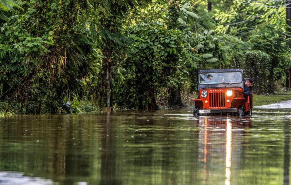 <div class="inline-image__caption"><p>Juan Antonio Molina drives his old jeep through a road flooded in Toa Alta by Hurricane Fiona.</p></div> <div class="inline-image__credit">Pedro Portal/Miami Herald via Getty</div>