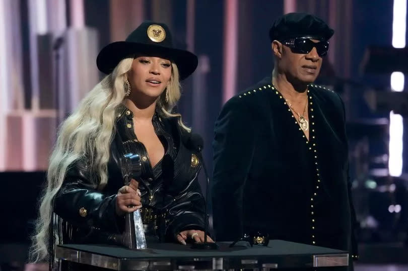 Beyonce, left, accepts the Innovator Award as presenter Stevie Wonder looks on during the iHeartRadio Music Awards, Monday, April 1, 2024, at the Dolby Theatre in Los Angeles. (AP Photo/Chris Pizzello)
