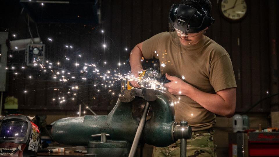 Staff Sgt. Gregory Bailey, 51st Maintenance Squadron metals technician, operates an angle grinder at Osan Air Base, South Korea, Sept. 7. If an aircraft component breaks, the 51st MXS aircraft metals technology section repairs it or fabricates a new component. (Staff Sgt. Thomas Sjoberg/Air Force)