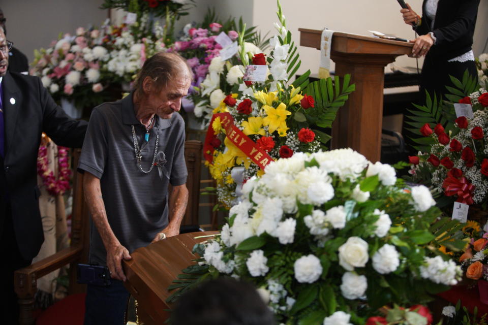 Antonio Basco, companion of Margie Reckard, leans on her casket during her funeral at La Paz Faith Memorial & Spiritual Center, Friday, Aug. 16, 2019, in El Paso, Texas. Reckard was killed during the mass shooting on Aug. 3. (AP Photo/Jorge Salgado)