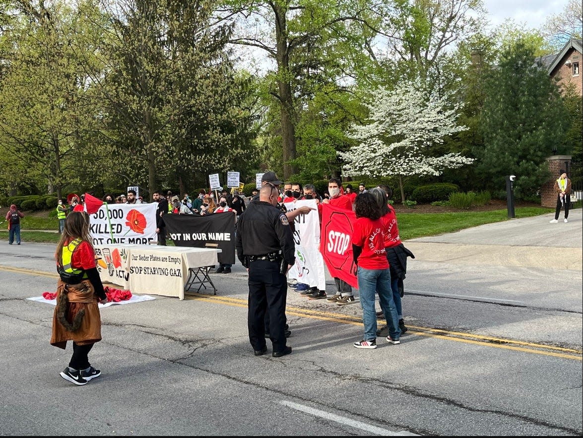 Protesters calling for a ceasefire in Gaza stand outside the Governor's Mansion on North Meridian Street on April 25, 2024.