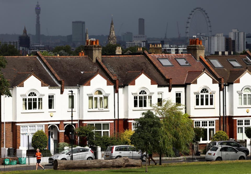 House price  A person jogs past a row of residential housing in south London, Britain, August 6, 2021. REUTERS/Henry Nicholls