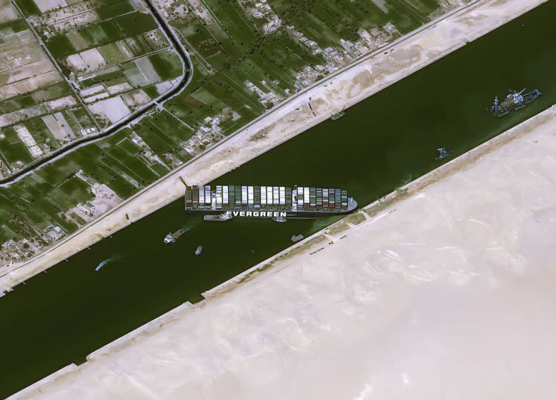 This satellite image from Cnes2021, Distribution Airbus DS, shows the cargo ship MV Ever Given stuck in the Suez Canal near Suez, Egypt, Thursday, March 25, 2021. The skyscraper-sized cargo ship wedged across Egypt's Suez Canal further imperiled global shipping Thursday as at least 150 other vessels needing to pass through the crucial waterway idled waiting for the obstruction to clear, authorities said. (Cnes2021, Distribution Airbus DS via AP)