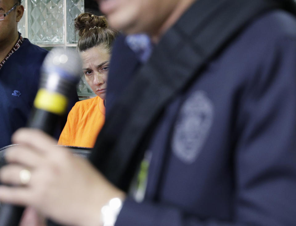 American Jennifer Erin Talbot from Ohio listens during a press conference by the National Bureau of Investigation (NBI) in Manila, Philippines on Thursday, Sept. 5, 2019. The NBI said that the 43-year-old Talbot was arrested at the Ninoy Aquino International Airport yesterday for trying to bring out of the country a 6-day old Filipino baby without proper travel documents. (AP Photo/Aaron Favila)