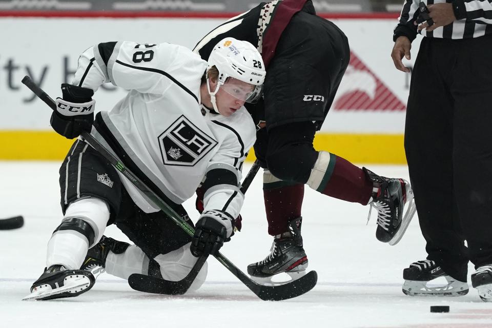 Los Angeles Kings center Jaret Anderson-Dolan (28) wins a face-off against Arizona Coyotes center Derick Brassard during the first period of an NHL hockey game Monday, May 3, 2021, in Glendale, Ariz. (AP Photo/Ross D. Franklin)