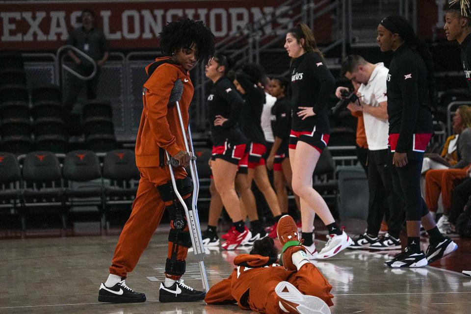 Texas guard Rori Harmon walks off the court in crutches ahead of the Longhorns' home game against Cincinnati on Jan. 27. She had surgery on her injured knee in January and has recently started shooting free throws but acknowledges that she's still using weeks, not months, in terms of her rehab.