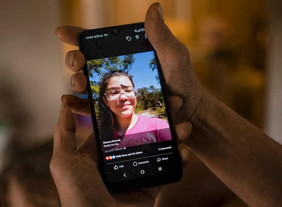 Shawna Normali holds up her favorite photo of her daughter, Lena Corona. Corona was in psychosis when she was arrested in July and taken to the Seminole County jail where she died by suicide in a cell.