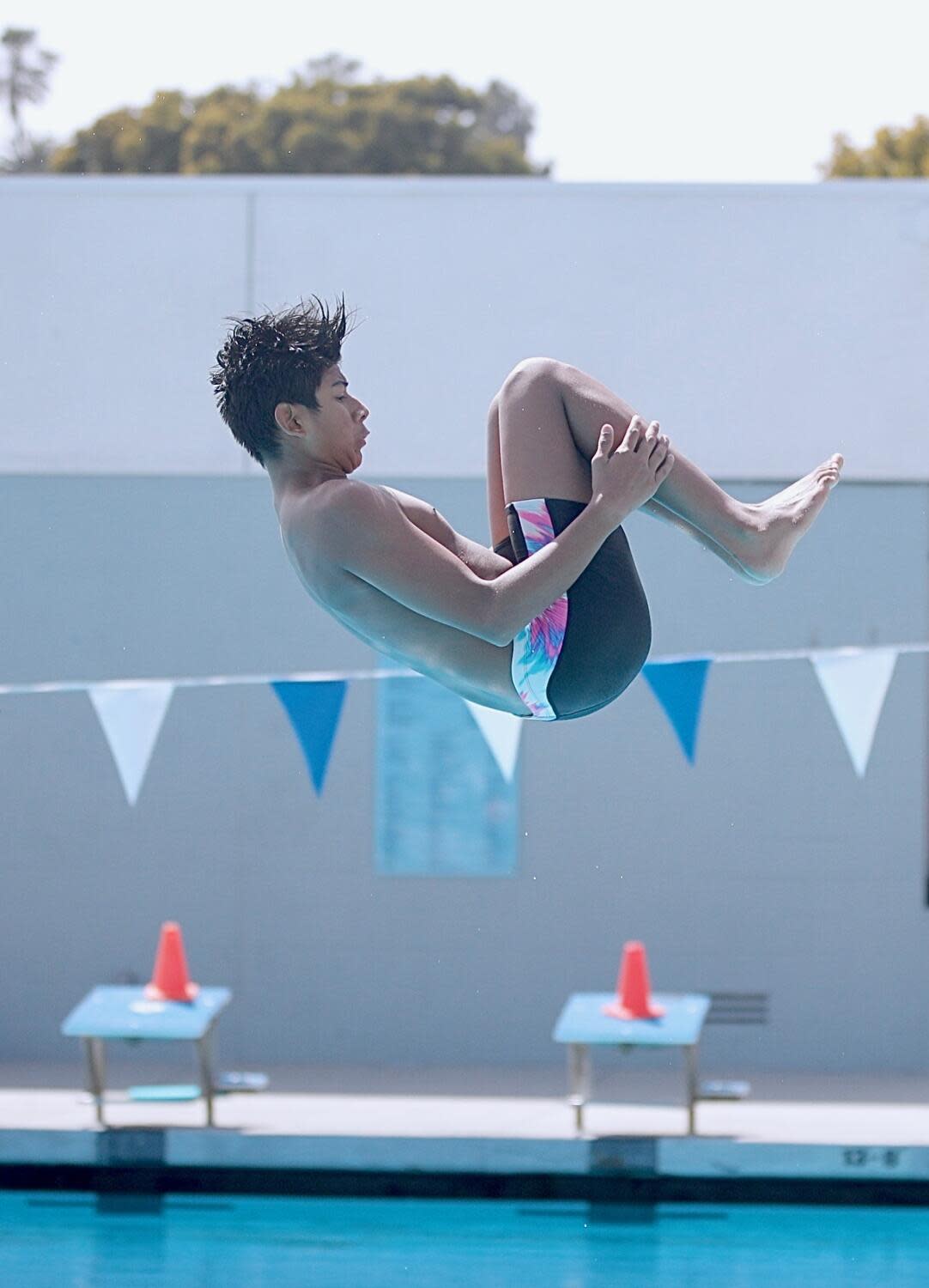 Josiah Rosales-Cristales tucks during a dive in the CIF City Section boys' diving championships.