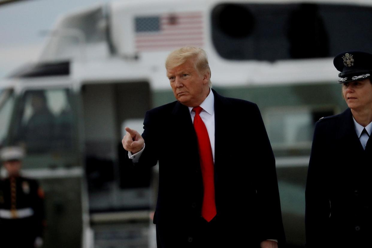 Donald Trump walks to board boards Air Force One as he departs Washington on Tuesday