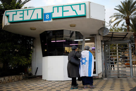 Workers of Teva Pharmaceutical Industries stand at the entrance to their facility in Ashdod, Israel December 17, 2017. REUTERS/Amir Cohen