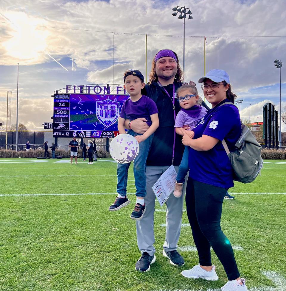 Holy Cross offensive coordinator Chris Smith, his wife, Natalie, and their children, Calvin and Eleanor.