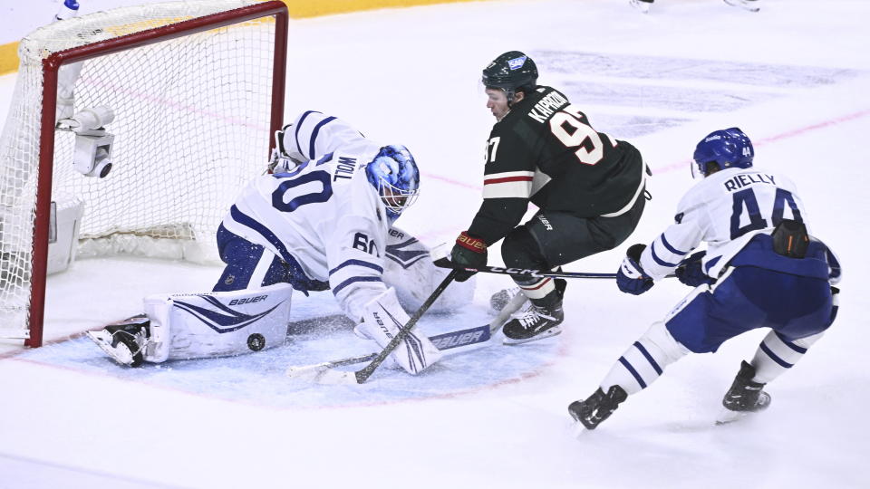 From left, Toronto's goalkeeper Joseph Woll, Minnesota's Kirill Kaprizov and Toronto's Morgan Rielly in action during the second period of the NHL Global Series Sweden ice hockey match between Toronto Maple Leafs and Minnesota Wild at Avicii Arena in Stockholm, Sweden, Sunday, Nov. 19, 2023. (Claudio Bresciani/TT via AP)