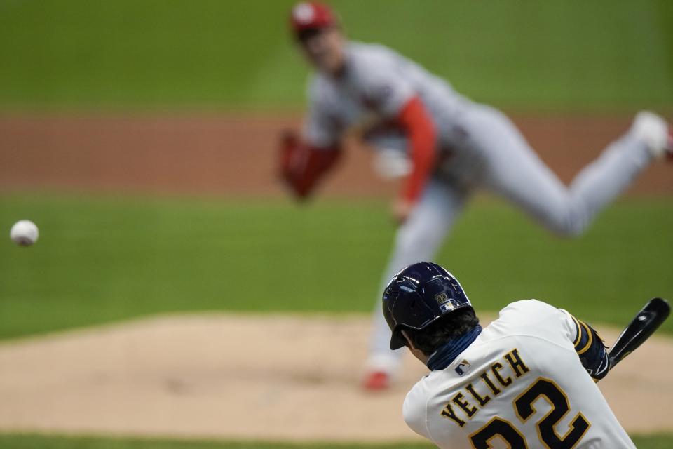 Milwaukee Brewers' Christian Yelich hits a double off St. Louis Cardinals starting pitcher Kwang Hyun Kim during the first inning of the first game of a baseball doubleheader Monday, Sept. 14, 2020, in Milwaukee. (AP Photo/Morry Gash)