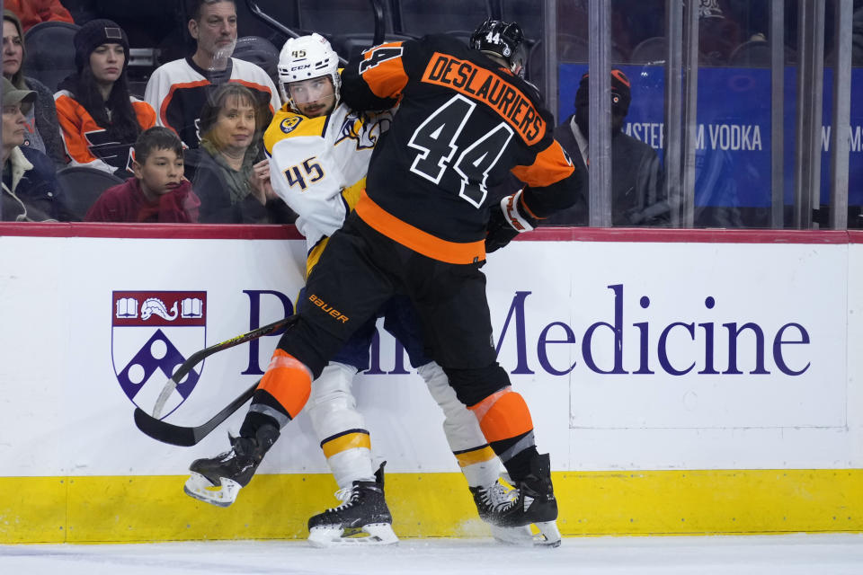 Nashville Predators' Alexandre Carrier, left, and Philadelphia Flyers' Nicolas Deslauriers collide during the first period of an NHL hockey game, Thursday, Dec. 21, 2023, in Philadelphia. (AP Photo/Matt Slocum)