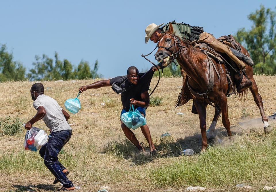 Un oficial de la Patrulla Fronteriza a caballo trata de detener a un inmigrante haitiano que ingresó a Estados Unidos en la zona de Del Río, Texas. (Getty Images)