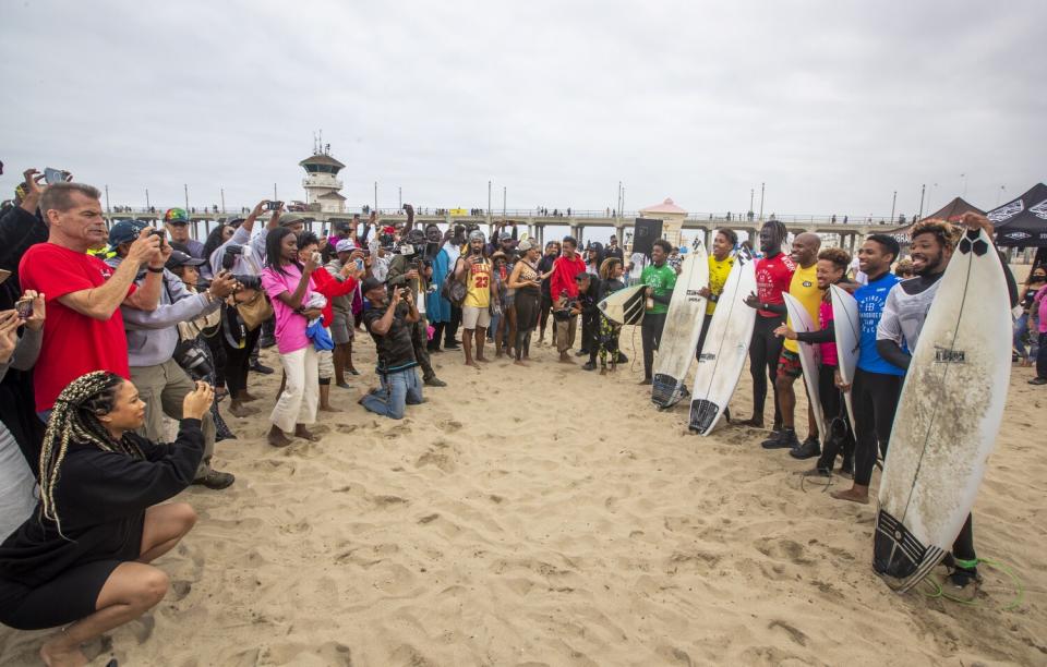 The men's finalists are cheered on and pose with their boards at "A Great Day in the Stoke" at Huntington Beach.