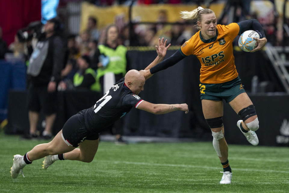 Canada's Olivia Apps, left, tries to tackle Australia's Maddison Levi, right, during bronze-medal Vancouver Sevens women's rugby match action in Vancouver, British Columbia, Sunday, Feb. 25, 2024. (Ethan Cairns/The Canadian Press via AP)