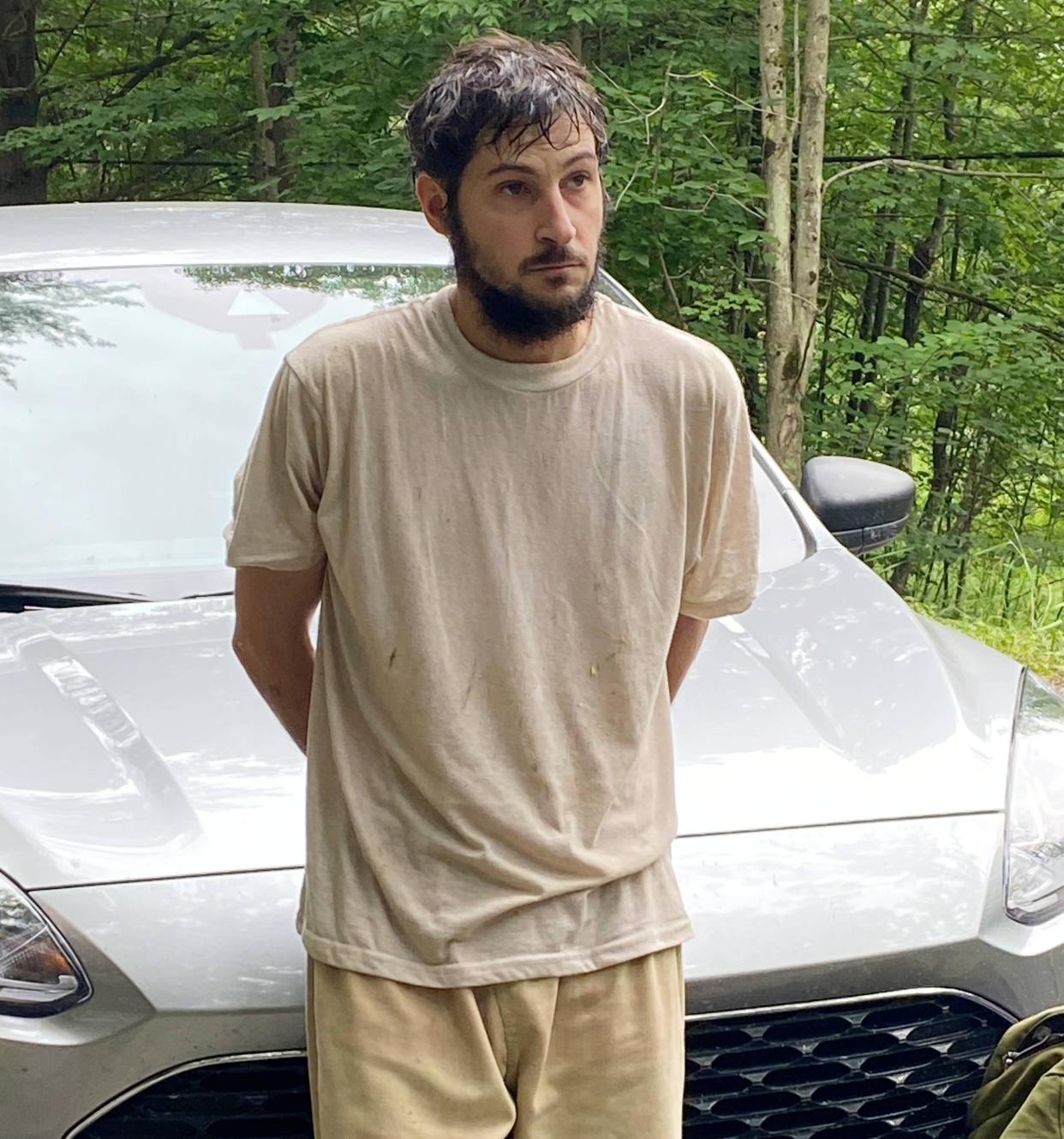 Michael C. Burham, 34, escaped from the Warren County Prison on July 6 He is pictured here in police custody on Saturday.