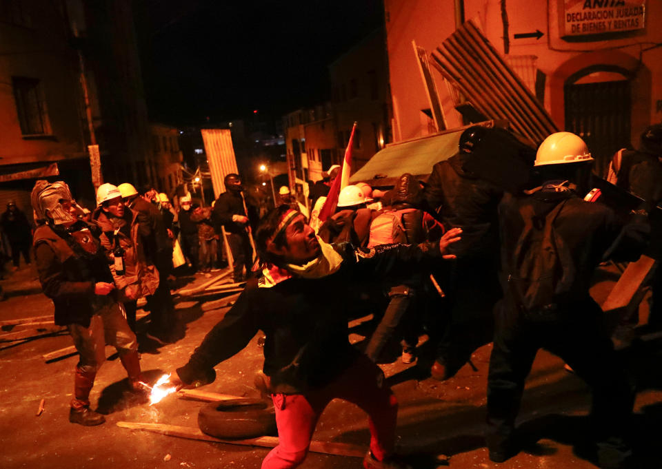 A demonstrator prepares to throw a molotov cocktail during clashes between protesters against Bolivia's President Evo Morales and government supporters, in La Paz, Bolivia Nov. 7, 2019. (Photo: Kai Pfaffenbach/Reuters)