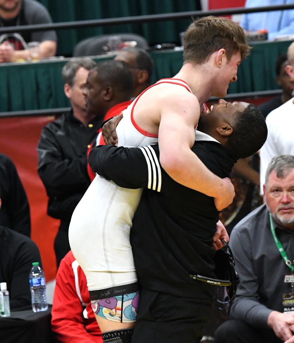 Carson Thomas gets a hug from La Salle coach Rico Hill after winning the 175-pound title at the 2024 OHSAA DI Wrestling State Tournament, Columbus, Ohio, March 10.