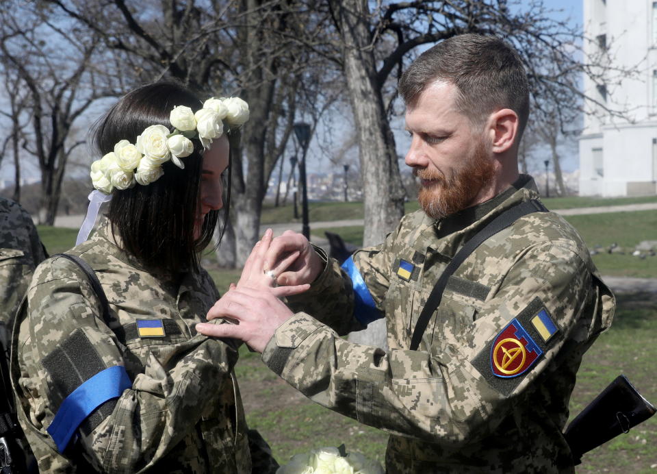 Members of the Ukrainian Territorial Defence Forces Anastasiia (24) and Viacheslav (43) attend their wedding ceremony, amid Russia's invasion of Ukraine, in Kyiv, Ukraine, April 7, 2022. REUTERS/Mykola Tymchenko