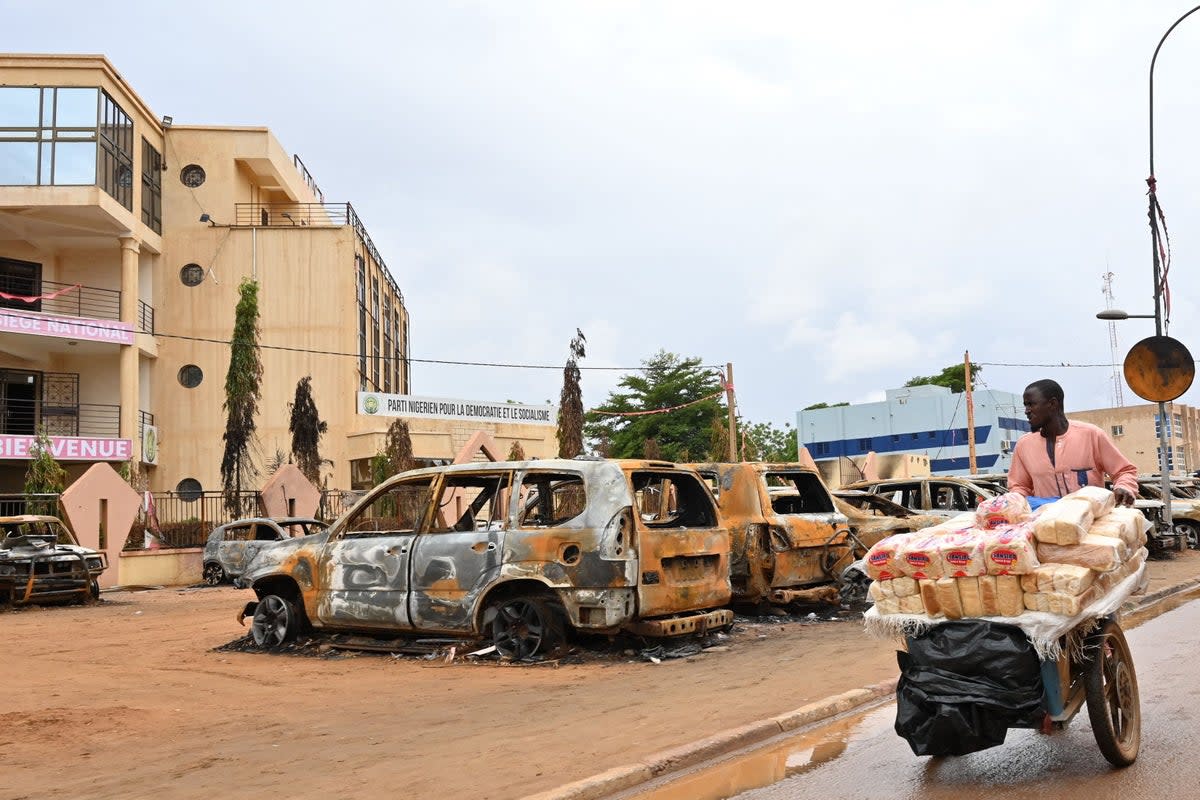 A street vendor outside the headquarters of ousted president on Monday (AFP)