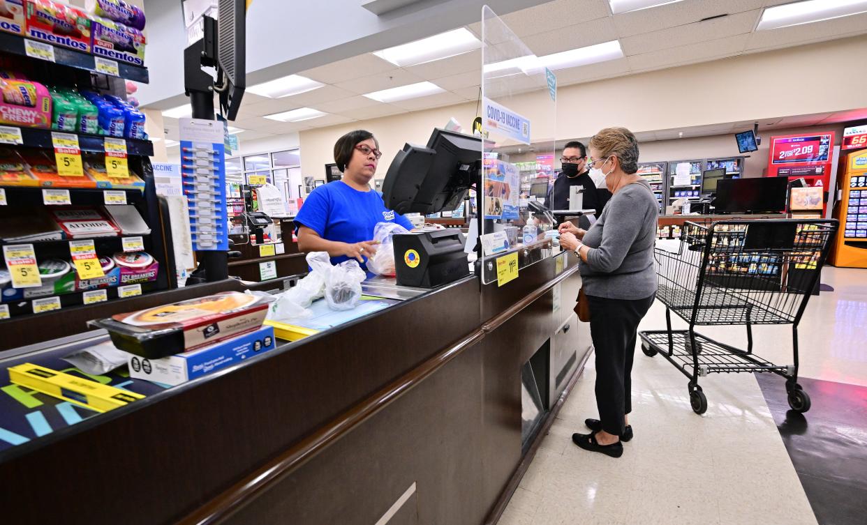 People stand at the check-out counter after shopping at a grocery supermarket in Alhambra, California, on July 13, 2022. - US consumer price inflation surged 9.1 percent over the past 12 months to June, the fastest increase since November 1981, according to government data released on July 13. Driven by record-high gasoline prices, the consumer price index jumped 1.3 percent in June, the Labor Department reported. (Photo by Frederic J. BROWN / AFP) (Photo by FREDERIC J. BROWN/AFP via Getty Images)