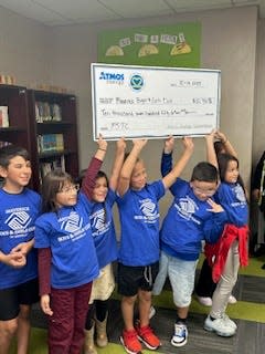 Maverick Boys and Girls Club of Amarillo Shining Stars hold the check representing the $10,750 donation from Atmos Energy. It was presented to the organization Thursday afternoon at the club's location, 1923 S Lincoln St.