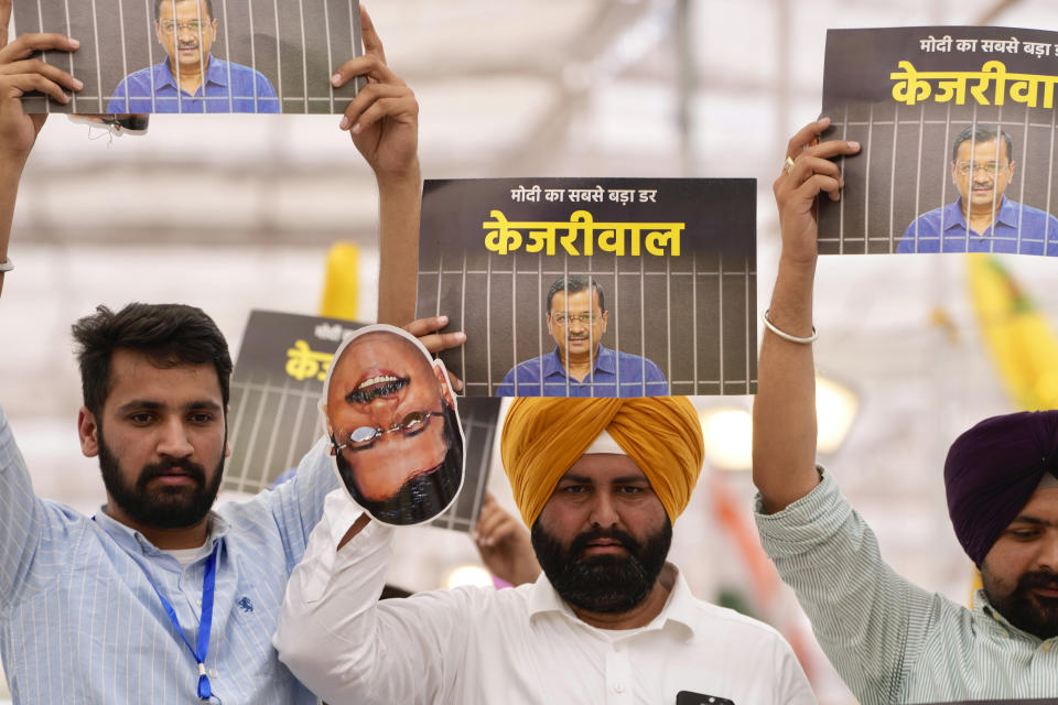 Supporters of the Aam Admi Party leader and Delhi Chief Minister Arvind Kejriwal hold posters at a protest rally organized by INDIA bloc, a group formed by opposition parties, in New Delhi, India, Sunday, March 31, 2024. Protesters are demanding the release of the top elected official of New Delhi who was arrested on March 21 in a liquor bribery case. (AP Photo/Manish Swarup)