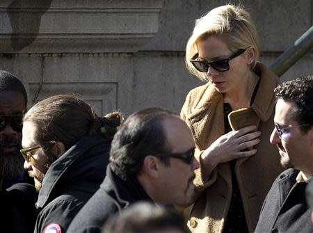 Actress Michelle Williams (R) leaves actor Philip Seymour Hoffman's funeral at St. Ignatius church in the Manhattan borough of New York February 7, 2014. REUTERS/Carlo Allegri