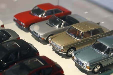 Peugeot miniature model vintage cars are lined-up in the store at French carmaker PSA Peugeot Citroen headquarters in Paris in this February 13, 2013 file photo. REUTERS/Charles Platiau/Files