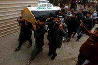 Mourners carry the coffin of a demonstrator, who was killed at an anti-government protest overnight in Baghdad, during the funeral in the holy city of Najaf