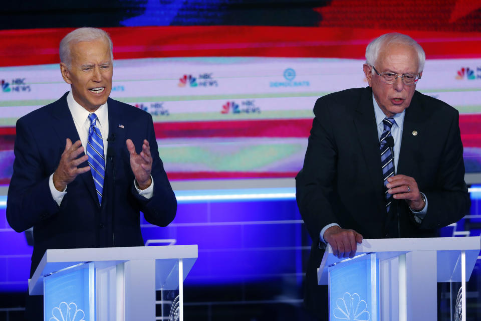 FILE - In this June 27, 2019, file photo, Democratic presidential candidates, former Vice President Joe Biden and Sen. Bernie Sanders, I-Vt., speak at the same time during the Democratic primary debate hosted by NBC News at the Adrienne Arsht Center for the Performing Arts in Miami. What might be the final showdown between the two very different Democratic candidates takes place Tuesday, March 17, 2020, during Florida's presidential primary. (AP Photo/Wilfredo Lee, File)