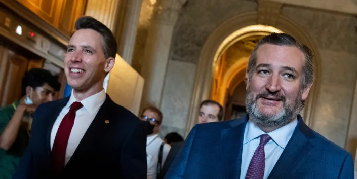 Republican Sens. Josh Hawley of Missouri and Ted Cruz of Texas walk to a GOP luncheon at the Senate on May 3, 2022.