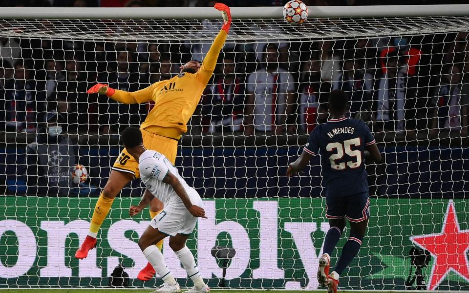 Manchester City's English midfielder Raheem Sterling (C) heads the ball past Paris Saint-Germain's Italian goalkeeper Gianluigi Donnarumma but hits the bar during the UEFA Champions League  - FRANCK FIFE/AFP via Getty Images