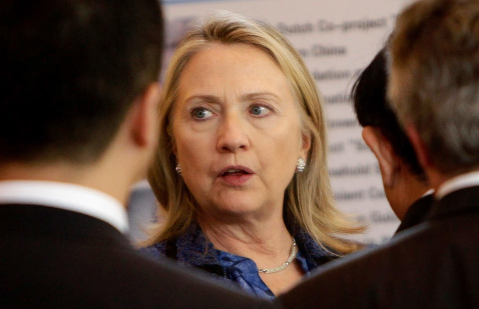 BEIJING, CHINA - MAY 3: U.S. Secretary of State Hillary Clinton (R) listens as China's Minister of Science and Technology Wan Gang (not pictured) introduces a cooking stove at an exhibition at Diaoyutai State Guesthouse on May 3, 2012 in Beijing. Hillary Clinton is in China for bilateral talks and has called on China to protect human rights. Chinese activist Chen Guangcheng has reportedly said he wishes to leave China on the U.S. Secretary of State's plane when she heads back to the U.S. later this week. (Photo by Jason Lee/Pool/Getty Images)