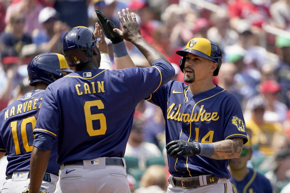 Milwaukee Brewers' Jace Peterson (14) is congratulated by teammate Lorenzo Cain (6) after hitting a three-run home run during the fifth inning of a baseball game against the St. Louis Cardinals Sunday, May 29, 2022, in St. Louis. (AP Photo/Jeff Roberson)