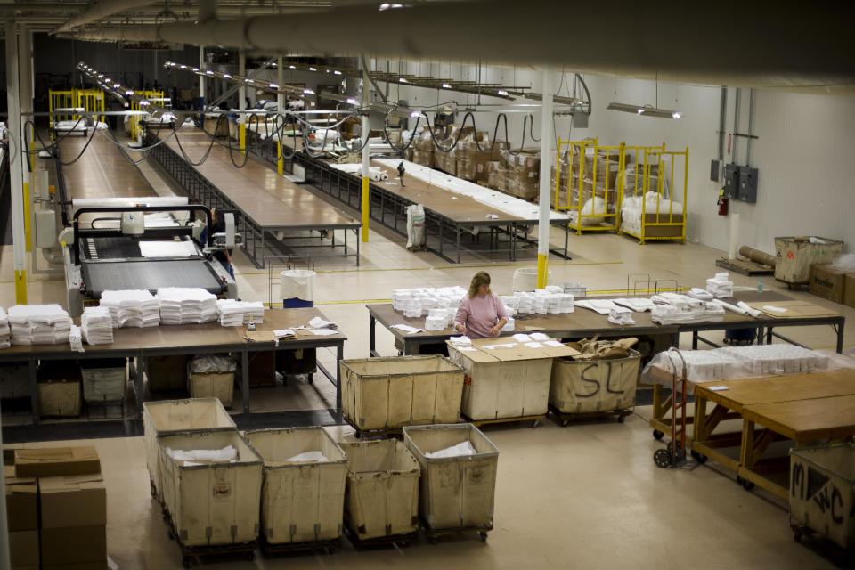 FILE - In this Monday, Oct. 15, 2012 file photo, Gloria Bambrick counts and stacks T-shirt components at FesslerUSA apparel manufacture in Orwigsburg, Pa. Superstorm Sandy depressed U.S. industrial output in October, while production of machinery and equipment declined sharply, reflecting a more cautious outlook among businesses, according to Federal Reserve reports, Friday, Nov. 16, 2012. (AP Photo/Matt Rourke, File)